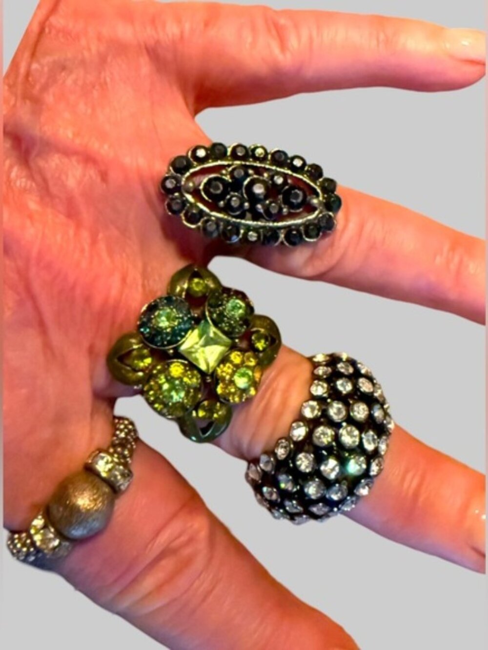 Collection of four adjustable band cocktail rings.
